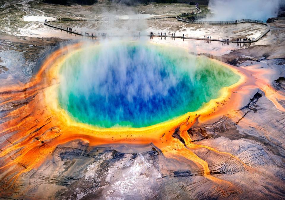 <p>It’s hard to believe that photos of the <a href="https://www.yellowstonepark.com/things-to-do/grand-prismatic-midway-geyser-basin" rel="nofollow noopener" target="_blank" data-ylk="slk:Grand Prismatic Spring;elm:context_link;itc:0;sec:content-canvas" class="link ">Grand Prismatic Spring</a> aren’t photoshopped. This natural pool with rainbow colors is the biggest hot spring in the U.S., and the third largest in the world. It’s located in Yellowstone National Park, which will make for a great weeklong (or longer!) escape from reality. </p>