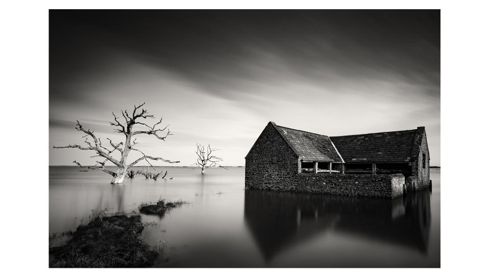Jeremy Walker Landscape photo showing farm like building in flooded landscape with bare tree