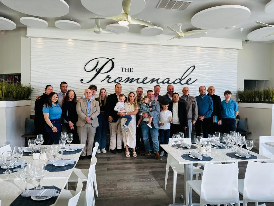 Carmen and Liam Moloney (center) have opened The Promenade, a restaurant on the boardwalk in Avon. The space previously housed Avon Pavilion.