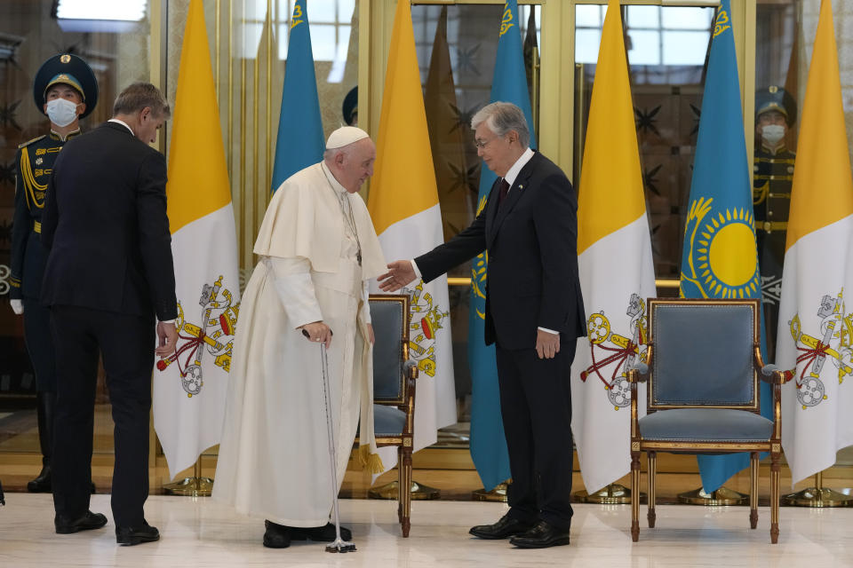 Pope Francis, left, meets the Kazakhstan's President Kassym-Jomart Tokayev as he arrives at Our-Sultan's International airport in Nur-Sultan, Kazakhstan, Tuesday, Sept. 13, 2022. Pope Francis begins a 3-days visit to the majority-Muslim former Soviet republic to minister to its tiny Catholic community and participate in a Kazakh-sponsored conference of world religious leaders. (AP Photo/Andrew Medichini)