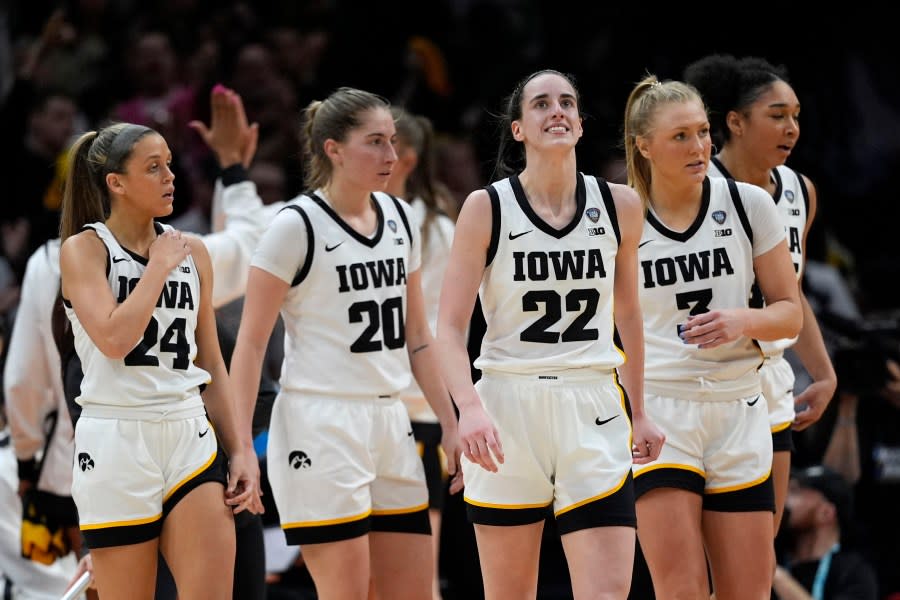 Iowa guard Caitlin Clark (22) reacts after making a three-point basket during the second half of a Final Four college basketball game against UConn in the women’s NCAA Tournament, Friday, April 5, 2024, in Cleveland. (AP Photo/Carolyn Kaster)