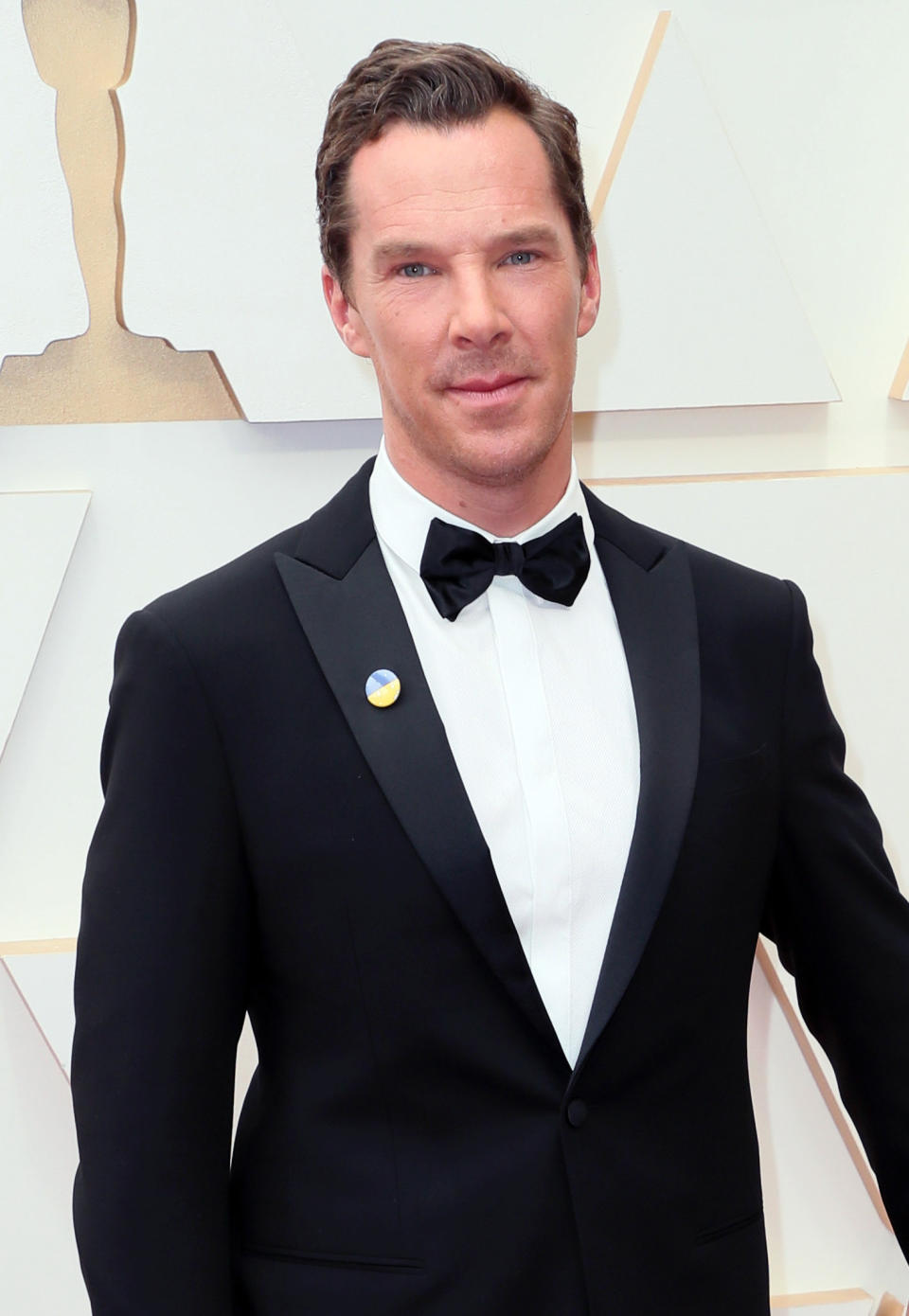 a serious and older Cumberbatch in a suit