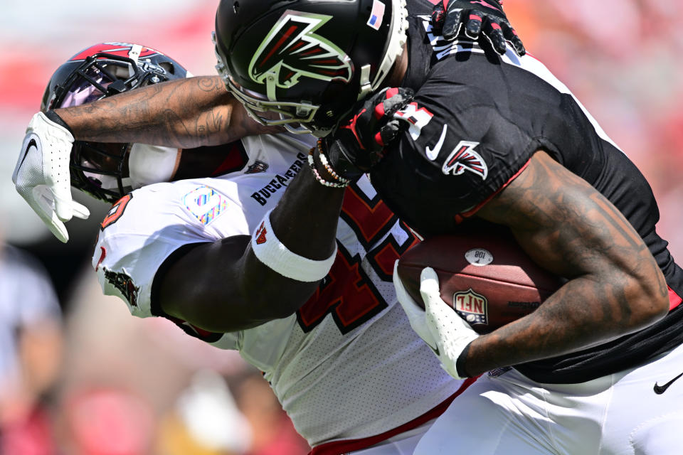 TAMPA, FLORIDA - OCTOBER 22: Devin White #45 of the Tampa Bay Buccaneers tackles Kyle Pitts #8 of the Atlanta Falcons during the first quarter of the game at Raymond James Stadium on October 22, 2023 in Tampa, Florida. (Photo by Julio Aguilar/Getty Images)