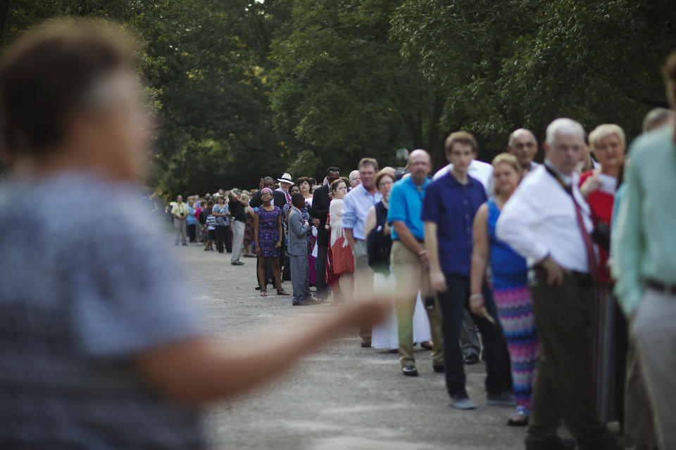Jan Williams gives instructions as people wait to enter Maranatha Baptist Church for Sunday School class by former President Jimmy Carter on Aug. 23, 2015, in Plains, Ga. (AP Photo/David Goldman)