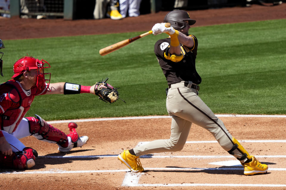 San Diego Padres' Jake Cronenworth follows through on a base hit against the Los Angeles Angels during the first inning of a spring training baseball game, Friday, March 24, 2023, in Tempe, Ariz. (AP Photo/Matt York)