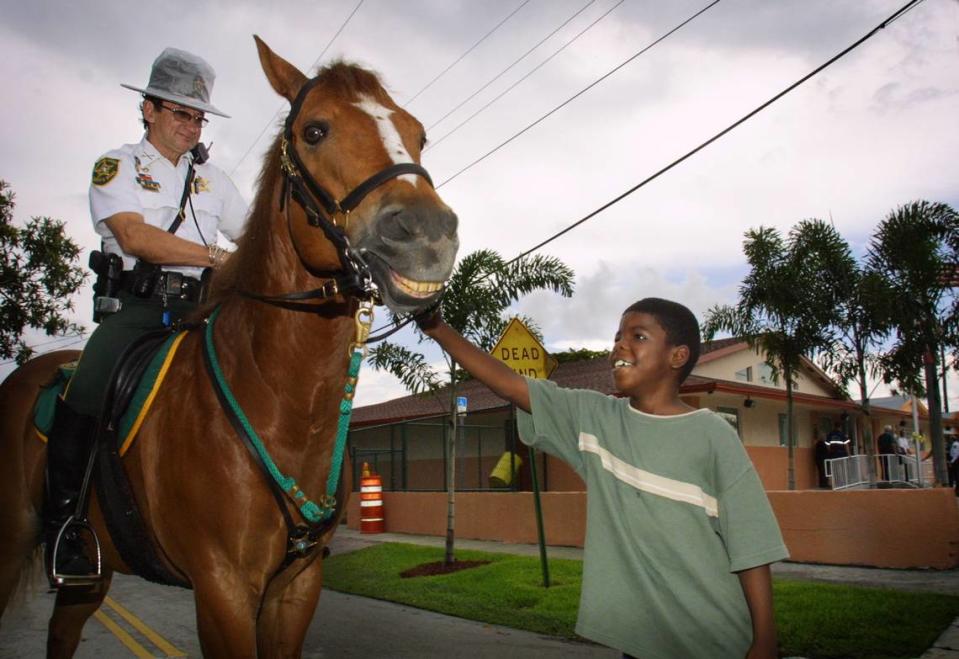 A Broward’ sheriff’s horse gets some TLC at the opening of a substation in Dania Beach 2003. In the photo, Shawn Branch, 8, pets Jackson, a 14-year-old American Quarterhorse rode by BSO Deputy Fred Parker of the BSO Mounted Patrol.