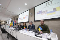 Digna van Boetzelaer, the Netherlands, Andy Kraag, the Netherlands, David McLean, Australia, Asha Hoe Soo Lian, Malaysia, Eric van der Sypt, Belgium, and Oleksandr Bannyk, Ukraine, from left to right, are seen during the Joint Investigation Team (JIT) holds a news conference in The Hague, Netherlands, Wednesday, Feb. 8, 2023, on the results of the ongoing investigation into other parties involved in the downing of flight MH17 on 17 July 2014. The JIT investigated the crew of the Buk-TELAR, a Russian made rocket launcher, and those responsible for supplying this Russian weapon system that downed MH17. (AP Photo/Peter Dejong)
