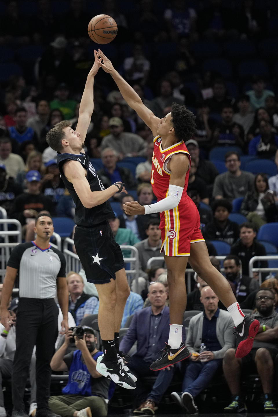 Orlando Magic's Franz Wagner, left, attempts a shot over Atlanta Hawks' Jalen Johnsonduring the first half of an NBA basketball game, Wednesday, Dec. 14, 2022, in Orlando, Fla. (AP Photo/John Raoux)