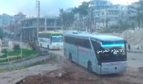 A still image taken from a video uploaded by the Syrian Army on April 19, 2017, shows buses carrying rebel fighters and their families leaving the the town of Zabadani, near Damascus, Syria. Syrian Army/Handout via Reuters TV