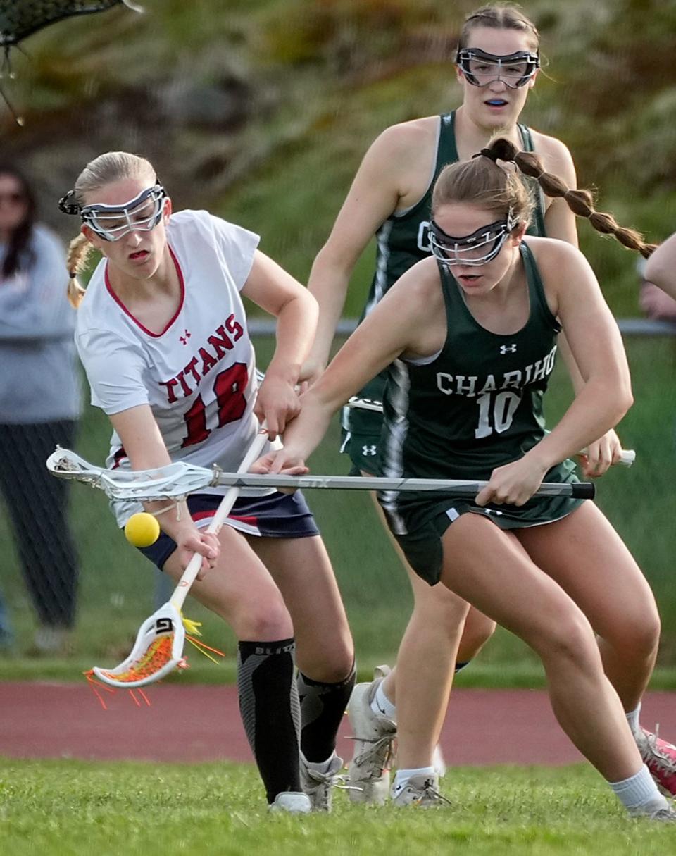 Toll Gate Titan Delanie Wheeler and Chariho Charger Aubrey Currier jockey for possession of a bouncing ball during game action Tuesday at Toll Gate. Chariho vs Tollgate in girls lacrosse. Chariho won 14-4.