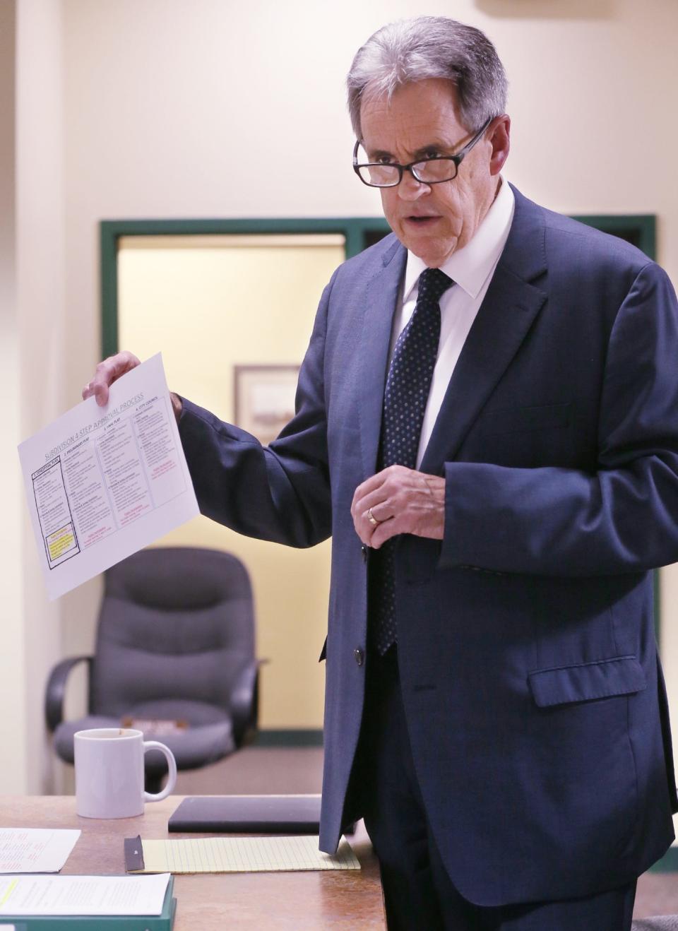 New Franklin Mayor Paul Adamson holds up a sheet that lays out the subdivision four-step approval process and explains to the audience that there will be no public comments during a Planning & Zoning Commission meeting Wednesday at new Franklin City Hall.