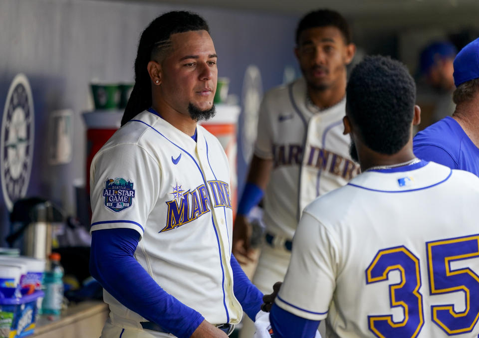 Seattle Mariners starting pitcher Luis Castillo talks with designated hitter Teoscar Hernandez (35) after pitching through the seventh inning of a baseball game against the Kansas City Royals, Sunday, Aug. 27, 2023, in Seattle. (AP Photo/Lindsey Wasson)