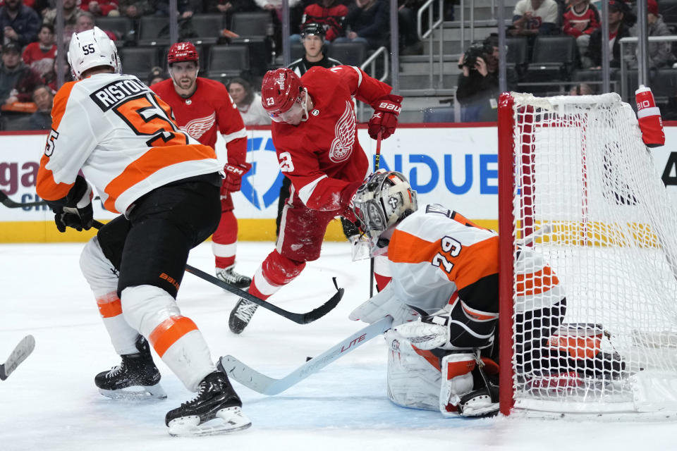 Philadelphia Flyers goaltender Carter Hart (79) stops a Detroit Red Wings left wing Lucas Raymond (23) shot in the third period of an NHL hockey game Saturday, Jan. 21, 2023, in Detroit. (AP Photo/Paul Sancya)