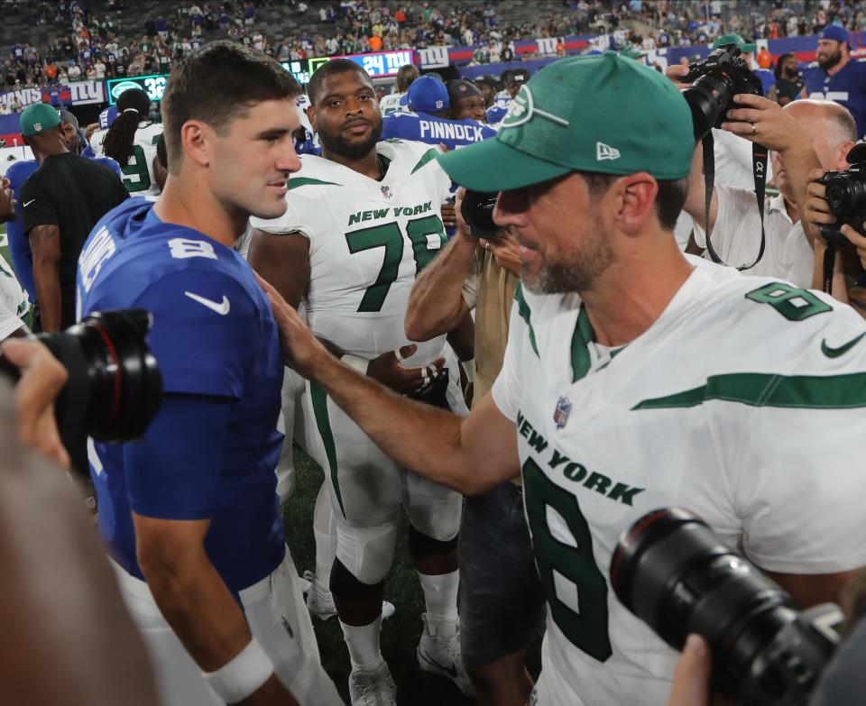 East Rutherford, NJ August 26, 2023 -- Jets quarterback Aaron Rodgers with NY Giants quarterback Daniel Jones at the end of the game. The NY Jets against the NY Giants on August 26, 2023 at MetLife Stadium in East Rutherford, NJ, as the rivals play their final preseason game before the start of the NFL season.
