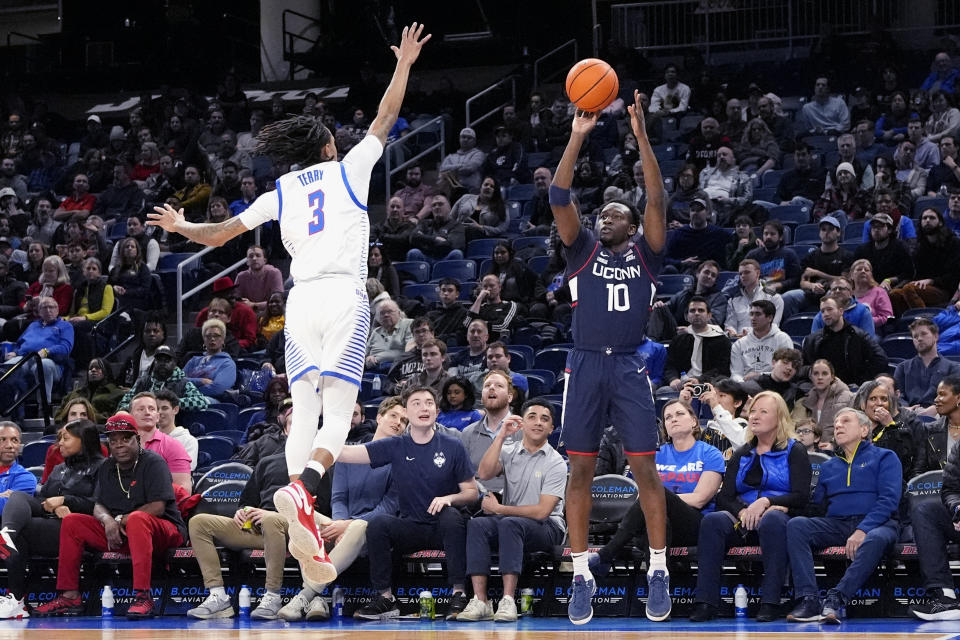 UConn guard Hassan Diarra, right, shoots against DePaul guard Jalen Terry during the first half of an NCAA college basketball game in Chicago, Wednesday, Feb. 14, 2024. (AP Photo/Nam Y. Huh)