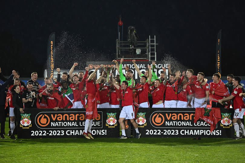 Ben Tozer and Luke Young of Wrexham lift the Vanarama National League Trophy.