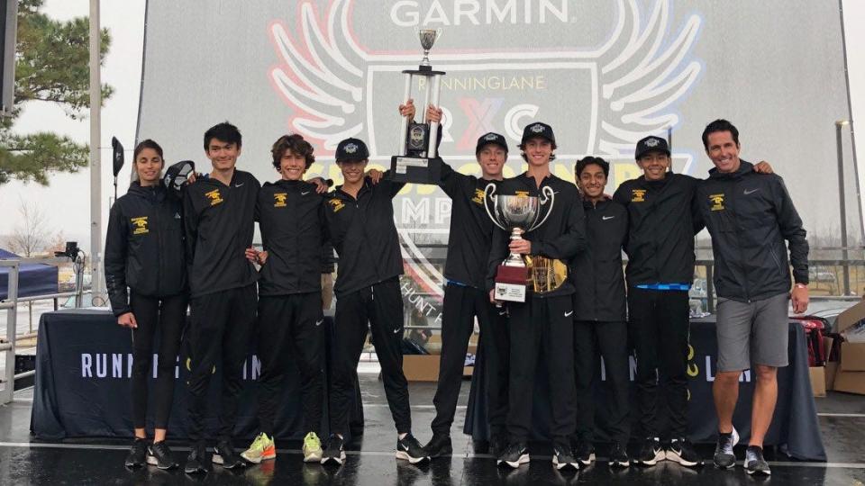 The Newbury Park High boys cross country team poses with its trophies after winning the Garmin RunningLane national championships in Huntsville, Alabama, on Saturday.