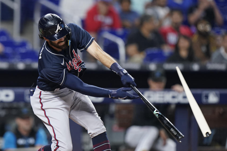 Atlanta Braves' Dansby Swanson breaks his bat as he gets a base hit during the first inning of a baseball game against the Miami Marlins, Monday, Oct. 3, 2022, in Miami. (AP Photo/Wilfredo Lee)