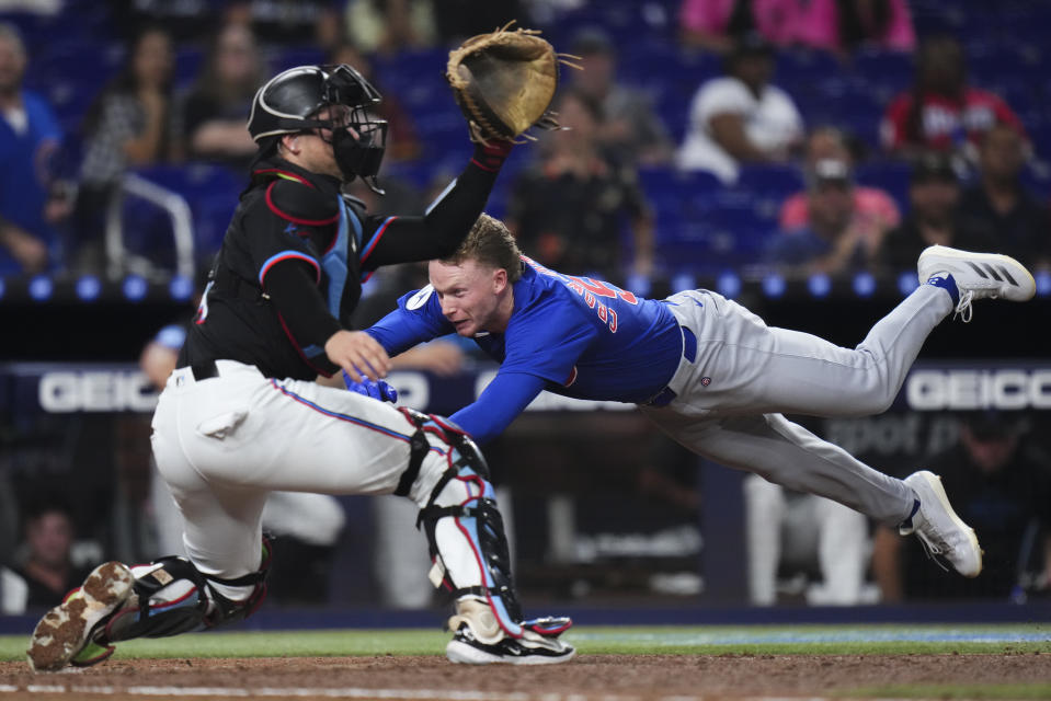 MIAMI, FLORIDA - AUGUST 23: Pete Crow-Armstrong #52 of the Chicago Cubs slides into home plate after hitting an inside-the-park home run against the Miami Marlins during the third inning at loanDepot park on August 23, 2024 in Miami, Florida. (Photo by Rich Storry/Getty Images)