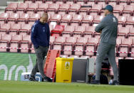 Manchester City's head coach Pep Guardiola, left, reacts as Southampton's manager Ralph Hasenhuettl watches during the English Premier League soccer match between Southampton and Manchester City at St. Mary's Stadium in Southampton, England, Sunday, July 5, 2020. (AP Photo/Will Oliver,Pool)