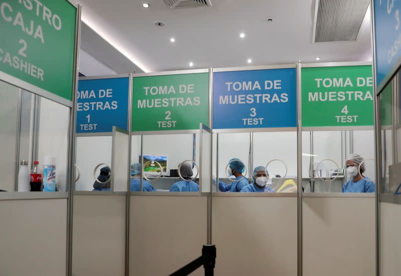 Healthcare workers sit in a booth offering coronavirus disease (COVID-19) tests for travelers at the Tocumen International Airport in Panama City