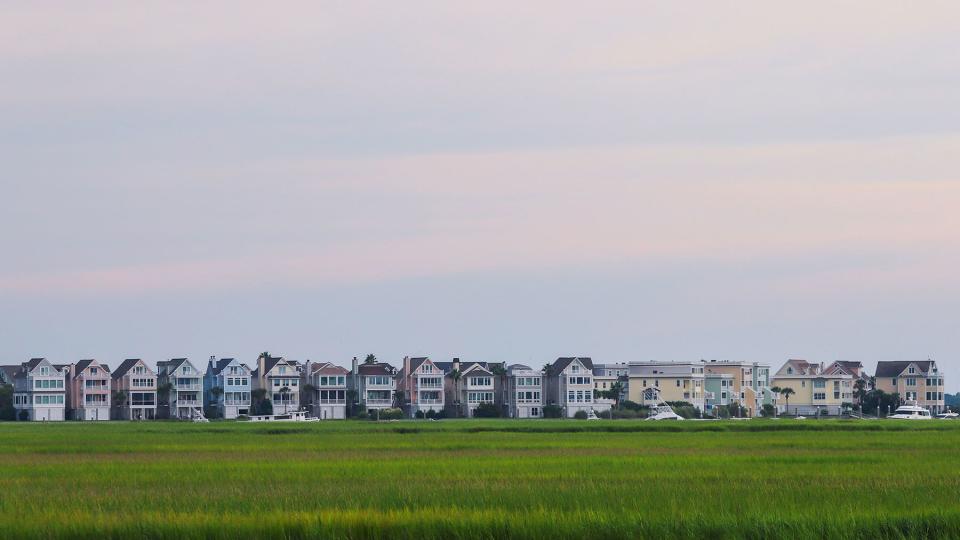 Coastal homes, the marsh and Ben Sawyer bridge can be seen from a distance, on a humid summer afternoon.