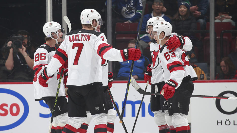 Jack Hughes #86, Dougie Hamilton #7, Jesper Bratt #63 of the New Jersey Devils celebrate after scoring on the Vancouver Canucks.  (Photo by Jeff Vinnick/NHLI via Getty Images)