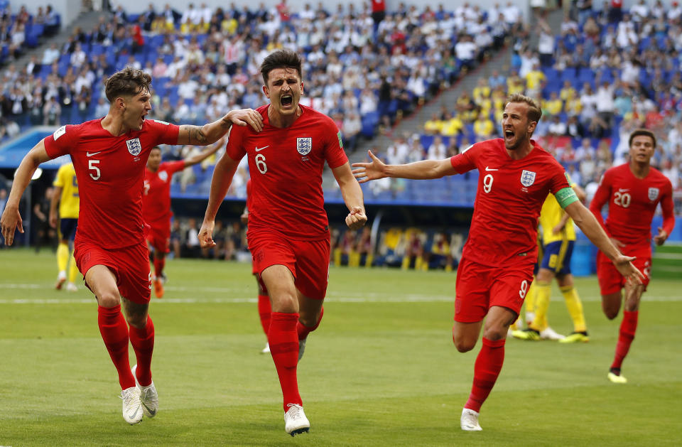 <p>England’s Harry Maguire, centre, celebrates with his teammates after scoring </p>