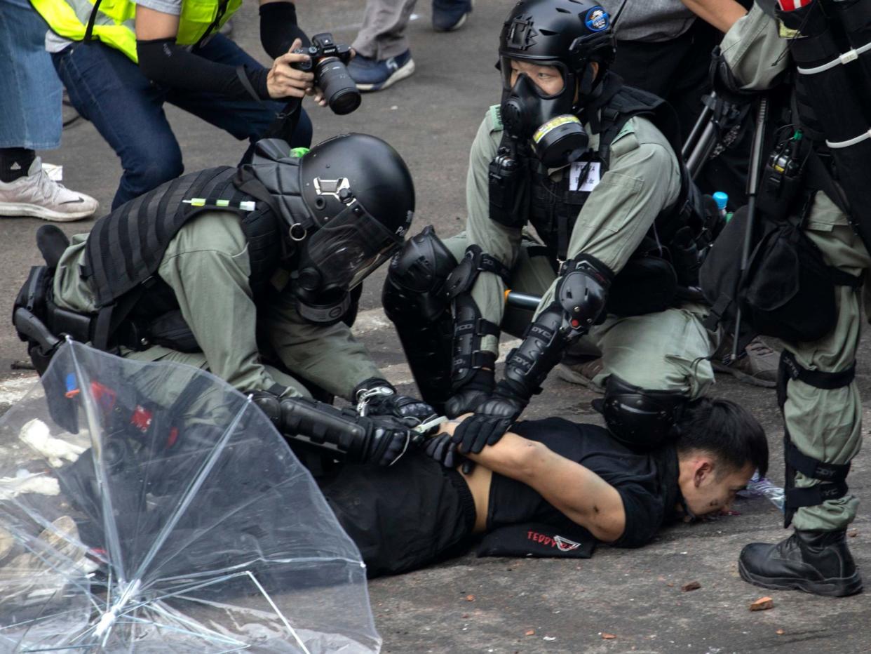 Police detain a protester at the Hong Kong Polytechnic University in Hong Kong: AP