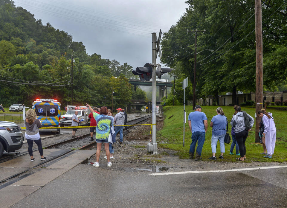 Residents gather along train tracks adjacent to a flooded underpass near Winifrede, W.Va., on Monday, Aug. 28, 2023. Parts of the area received up to 6 inches of rain. (Kenny Kemp/Charleston Gazette-Mail via AP)