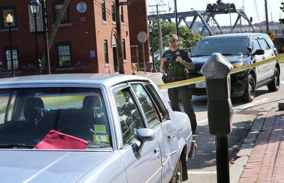 An Oldsmobile Cutlass Supreme is surrounded by crime tape on Daniel Street in Portsmouth Tuesday, Aug. 1, 2023, a short distance from where it struck a pedestrian near Prescott Park early in the morning, according to police.