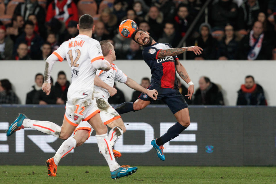 Paris Saint Germain's Ezequiel Lavezzi, right, heads the ball, during his French League one soccer match against Valenciennes, at the Parc des Princes stadium, in Paris, Friday, Feb. 14, 2014. (AP Photo/Thibault Camus)