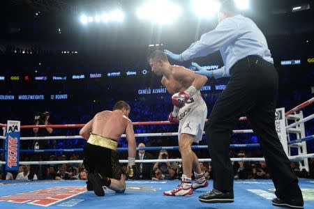 Sep 15, 2018; Las Vegas, NV, USA; Canelo Alvarez (black trunks) slips against Gennady Golovkin (white trunks) in the middleweight world championship boxing match at T-Mobile Arena. Alvarez won via majority decision. Mandatory Credit: Joe Camporeale-USA TODAY Sports