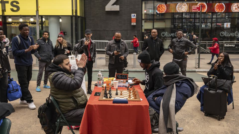 People celebrate as Tunde Onakoya marks 46 hours for consecutively playing a chess game in Times Square, Friday, April 19, 2024, in New York. - Yuki Iwamura/AP