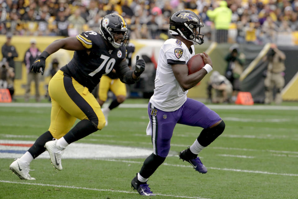 Baltimore Ravens quarterback Lamar Jackson (8) scrambles away from Pittsburgh Steelers nose tackle Javon Hargrave (79) in the first half of an NFL football game, Sunday, Oct. 6, 2019, in Pittsburgh. (AP Photo/Don Wright)