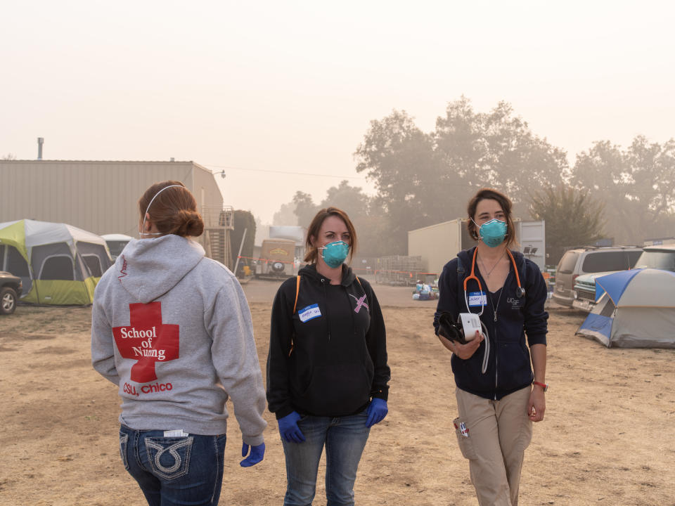 Sutter North RNs Jessica Garza and Maggie Page, along with UCSF RN Casey Domine, volunteer at the East Ave Community Church shelter, checking on victims of the Camp fire. (Photo: Cayce Clifford for HuffPost)