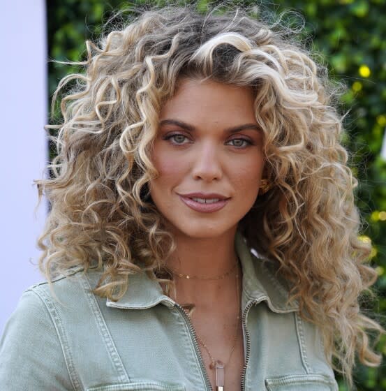 A young woman with curly blond hair