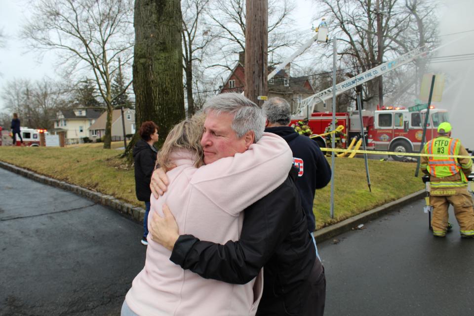 Piscataway Mayor Brian C. Wahler comforts FISH Executive Director Lisa Couch at the scene of a fire Wednesday at the longtime community food pantry and clothing distribution center on New Market Road.