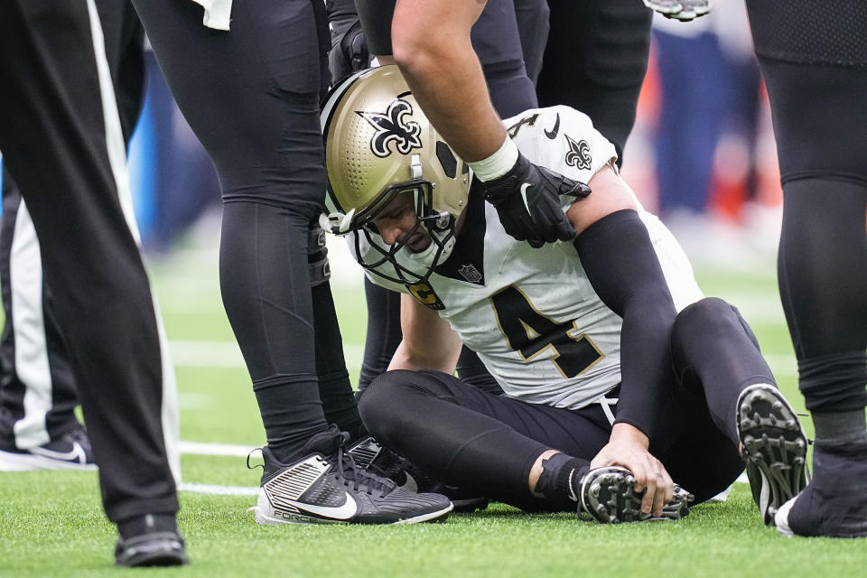New Orleans Saints quarterback Derek Carr (4) is helped after being sacked in the second half of an NFL football game against the Houston Texans in Houston, Sunday, Oct. 15, 2023. (AP Photo/Eric Gay)