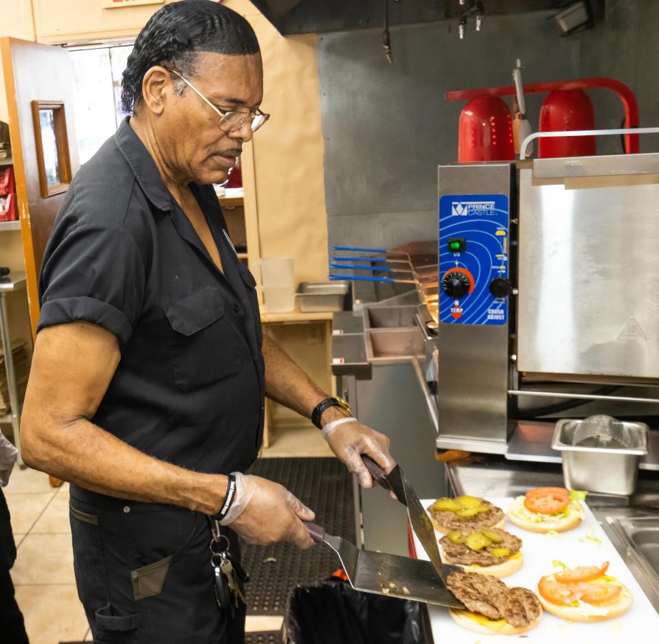 Jaws Jumbo Burgers co-owner Darryl Gaddis makes a few burgers Thursday at his restaurant, 3131 SW College Road, Suite 303, Ocala. The restaurant opens July 10.