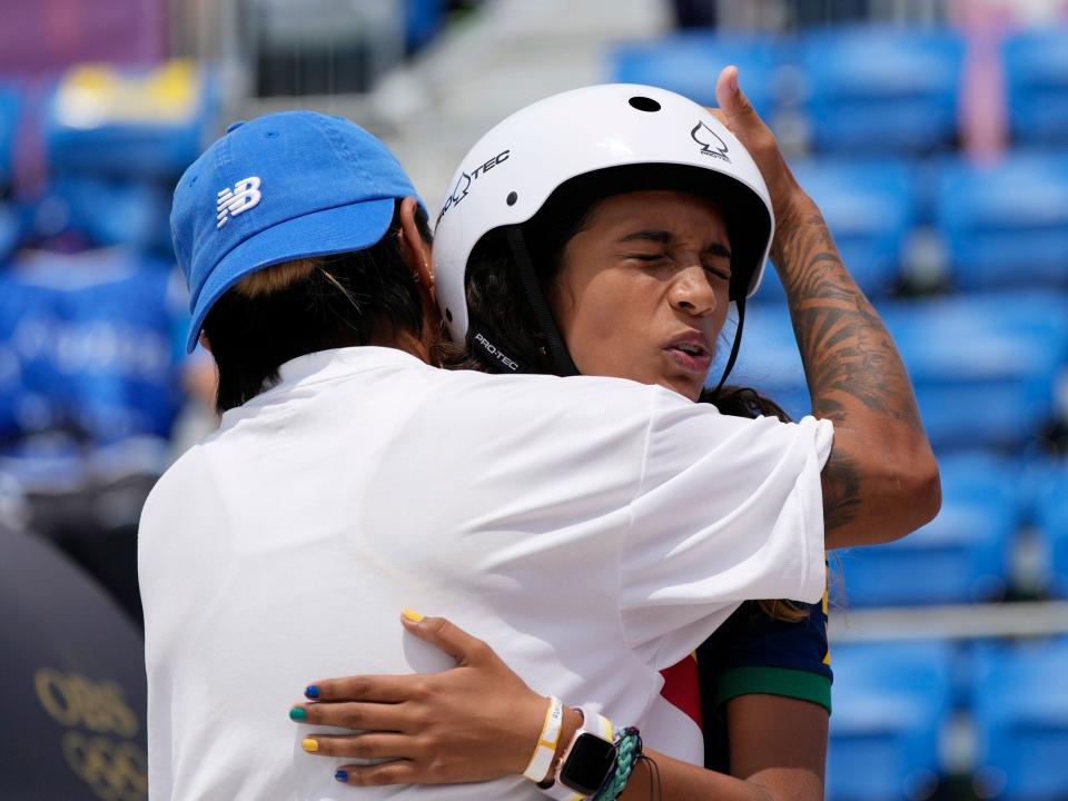 Rayssa Leal of Brazil is hugged after competing at Tokyo 2020.