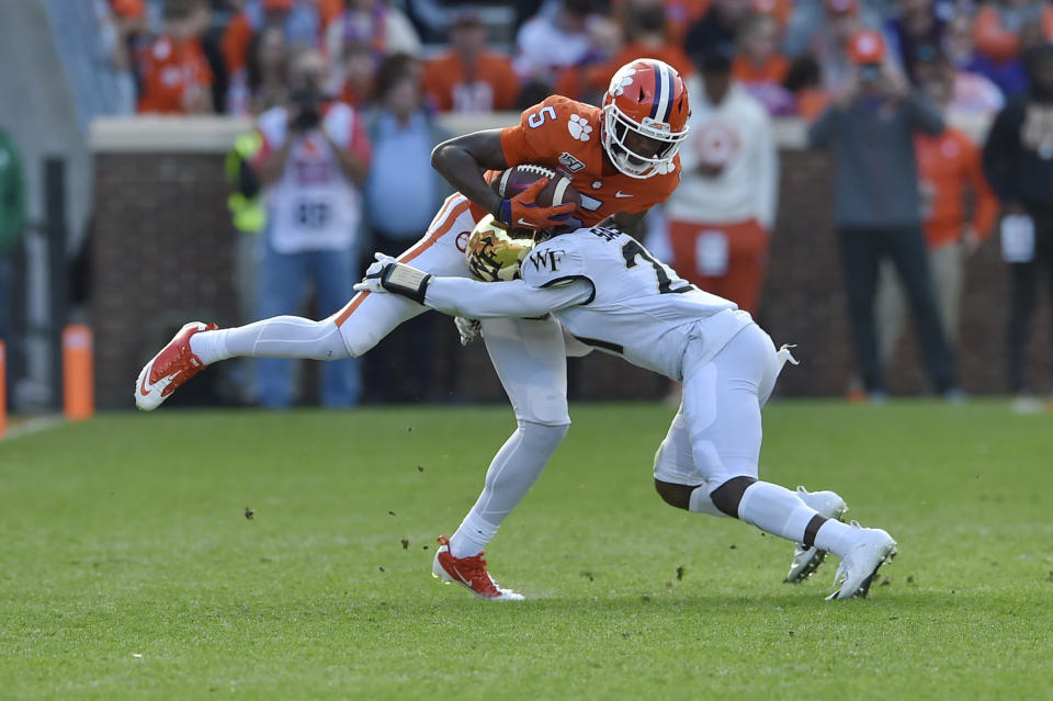 Clemson's Tee Higgins catches a pass while defended by Wake Forest's Essang Bassey (5) during the first half of an NCAA college football game Saturday, Nov. 16, 2019, in Clemson, S.C. (AP Photo/Richard Shiro)