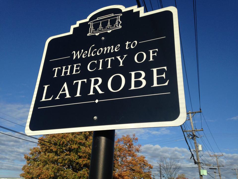 All the Latrobe city street signs are topped with trolleys.