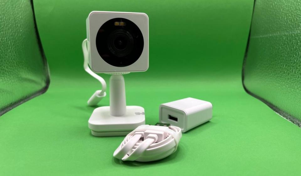 The Wyze Cam OG shown with its AC adapter and 6-foot USB cord.