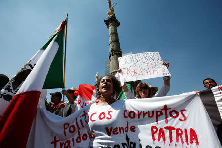 Demonstrators display messages against corruption and fascism during a protest against U.S. President Donald Trump's proposed border wall, and to call for unity, in Mexico City, Mexico, February 12, 2017. REUTERS/Ginnette Riquelme