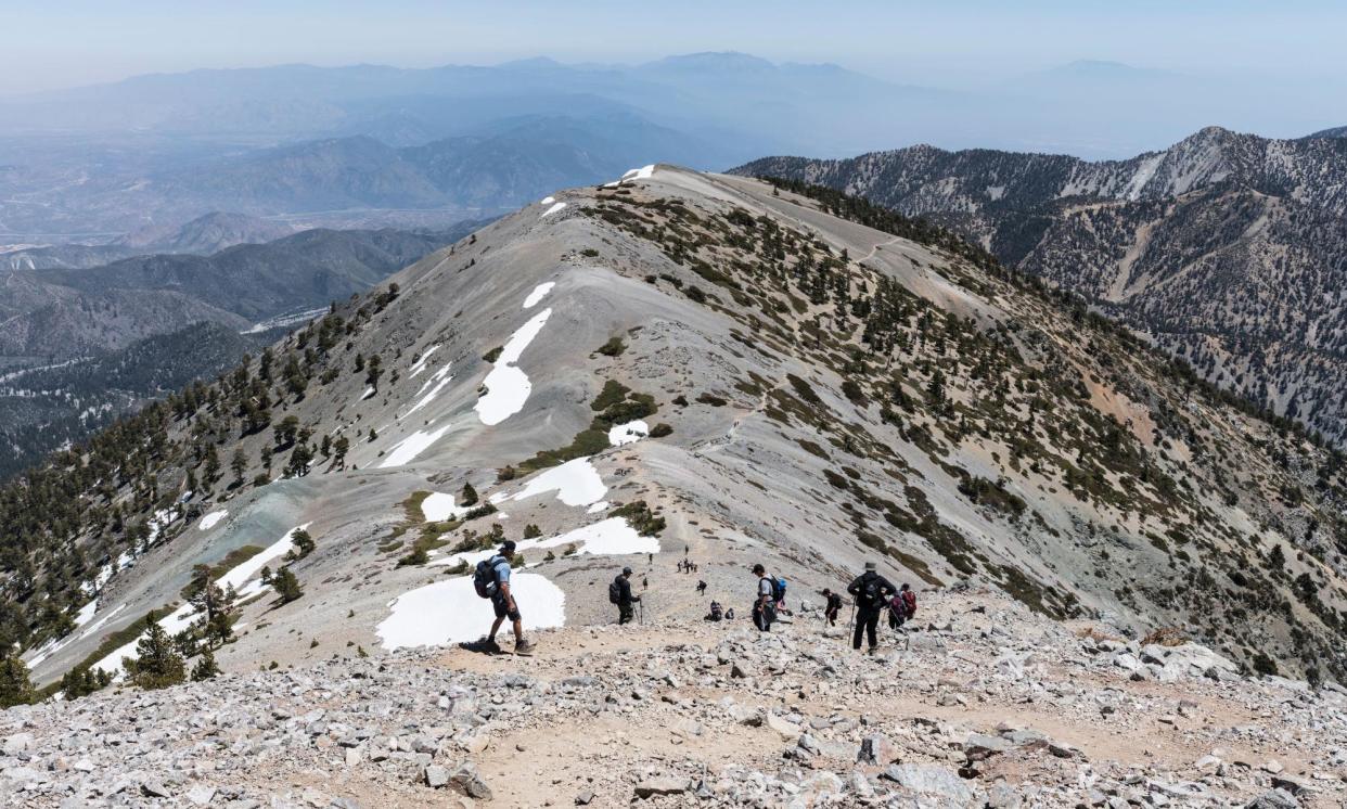 <span>Hikers descending the Devils Backbone trail on Mount Baldy in the San Gabriel Mountains near Los Angeles, in May 2022.</span><span>Photograph: trekandshoot/Alamy</span>