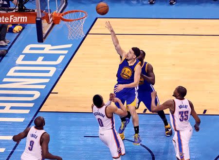 May 28, 2016; Oklahoma City, OK, USA; Golden State Warriors guard Klay Thompson (11) shoots past Oklahoma City Thunder guard Russell Westbrook (0)) during the second half in game six of the Western conference finals of the NBA Playoffs at Chesapeake Energy Arena. Mandatory Credit: Kevin Jairaj-USA TODAY Sports