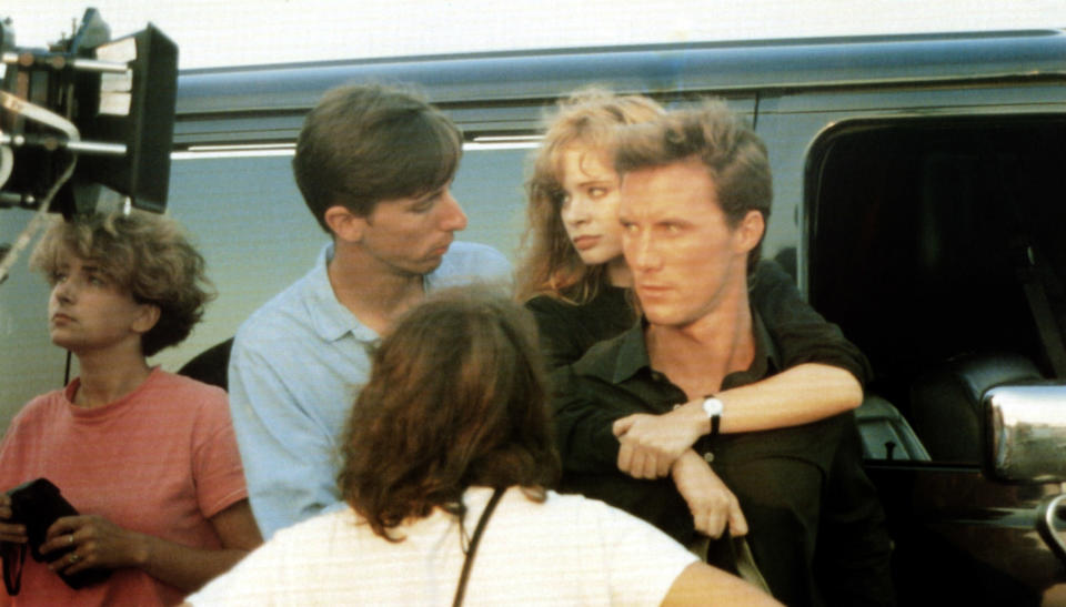 THE UNBELIEVABLE TRUTH, director Hal Hartley (blue shirt), Adrienne Shelly (arms around neck), Robert John Burke on set, 1989, © Miramax/courtesy Everett Collection