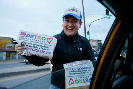 A supporter delivers political leaflets ahead of the second round of presidential election in Soacha, Colombia June 11, 2018. Picture taken June 11, 2018. REUTERS/Andres Stapff