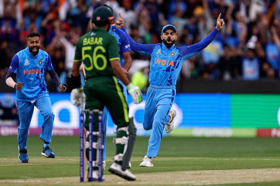 India's Virat Kohli (R) celebrates the wicket of Pakistan's Babar Azam during the ICC men's Twenty20 World Cup 2022 cricket match between India and Pakistan at Melbourne Cricket Ground (MCG) in Melbourne on October 23, 2022.